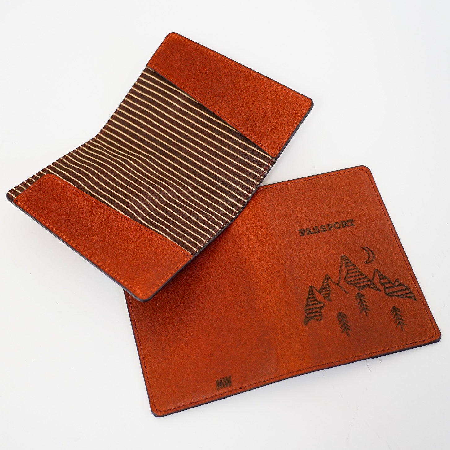 Two brown leather travel passport holder on a white background
